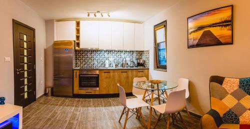 eine Küche mit Tisch und Kühlschrank in der Unterkunft Boutique 1-bedroom flat in the heart of the city in Plowdiw