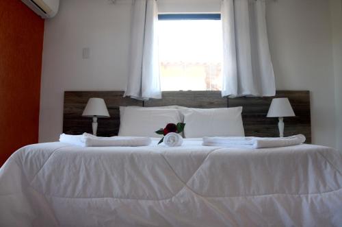 מיטה או מיטות בחדר ב-Pousada Kairos & Spa em Búzios