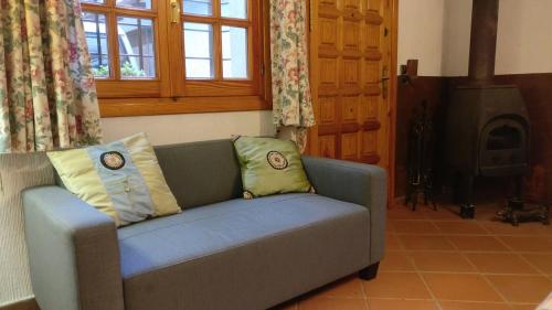 a living room with a couch and a wood stove at La Casita de Chozas in Soto Real