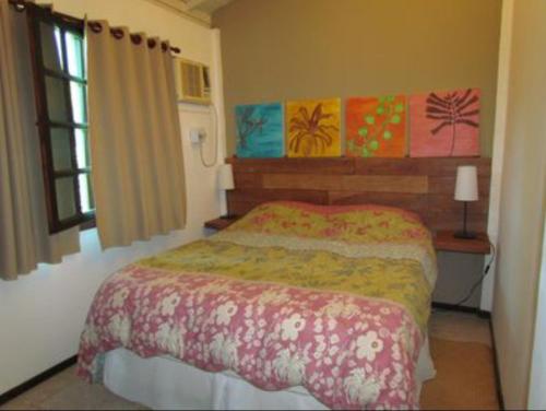 un dormitorio con una cama y una ventana en Casa Design Búzios Country, en Búzios