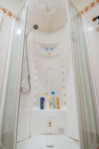 a shower stall with a toilet in a bathroom at Casa degli Orti, Dolomia best home in Trento