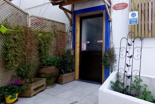 an entrance to a building with a door and some plants at Residencia do Parque in Odeceixe