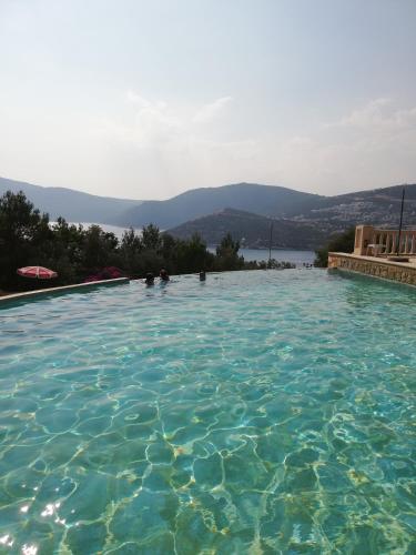 a swimming pool with a view of the water at Sea view Bougainvillea 52 in Kalkan