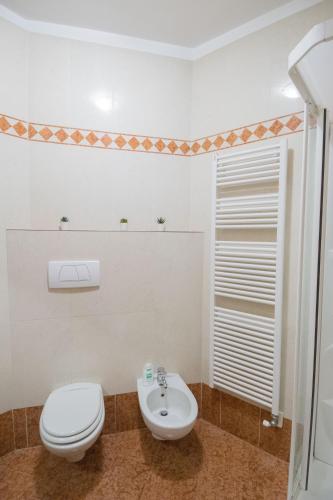 a bathroom with a toilet and a sink at Casa degli Orti, Dolomia best home in Trento