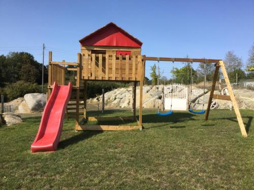 a playground with a slide and a play structure at GÎTE chez la petite marie à 40 mn du PUY DU FOU in Moncoutant