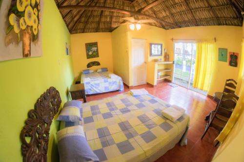 a bedroom with a large bed in a room at Hotel Cafe del Sol in Monterrico