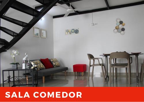 a living room with a couch and a table and chairs at CIC Apartamento amoblado Mirador del Sinú in Montería