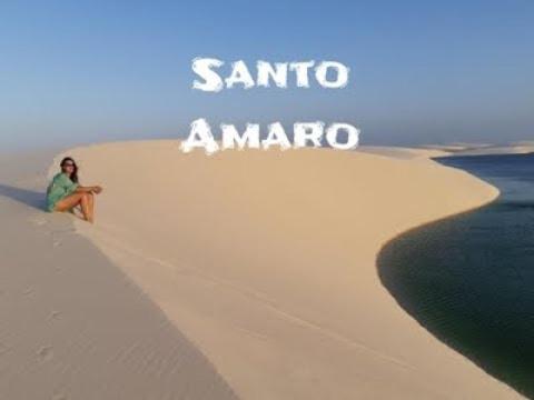 a woman sitting on a sand dune in the desert at Pousada Luz - Santo Amaro do Maranhão in Santo Amaro