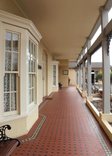 an empty hallway of a building with a red floor at Clifton Motel & Grittleton Lodge in Bunbury