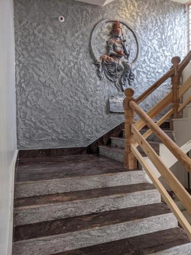 a staircase with a painting on the wall at Dip Holidays in Shānti Niketan