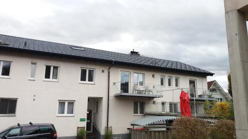 a white house with a black roof at Haus Edith Privathaus mit Gästezimmern in Bregenz