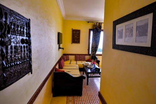 a hallway with a living room with a couch at Riad Zahra in Essaouira
