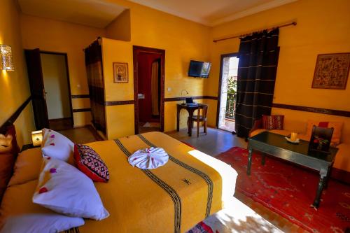 a bedroom with a bed and a table in a room at Riad Zahra in Essaouira