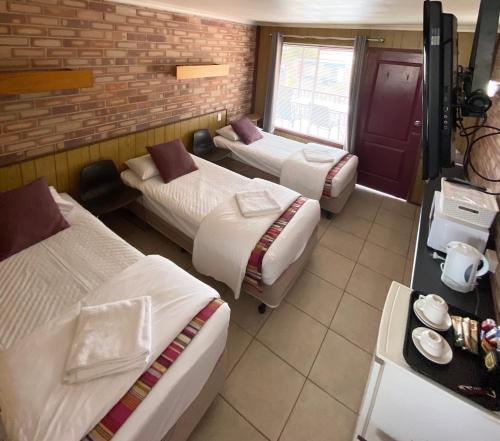 Postel nebo postele na pokoji v ubytování PROSERPINE MOTOR LODGE