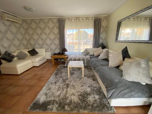 a living room with a couch and a table at Mar Menor Golf Villa - Frontline Detached - Heated Pool in Torre-Pacheco