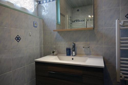 a bathroom with a sink and a mirror at La Crova in Félines