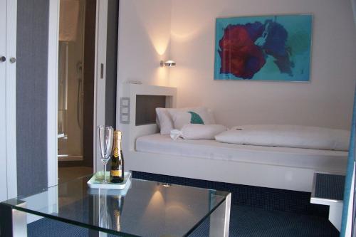 a living room with a white couch and a glass table at Gästehaus Margarete in Bad Wiessee