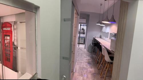 a hallway with a red door and a dining room at Marilyn City Center in Pécs