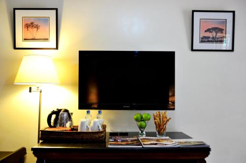 a flat screen tv on a wall in a hotel room at Muthu Lake Naivasha Country Club, Naivasha in Naivasha
