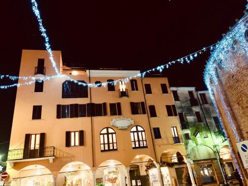 a building with christmas lights in front of it at Grand Hotel San Lorenzo in Mantova