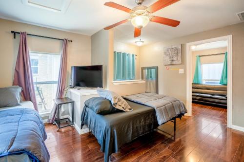 a bedroom with two beds and a flat screen tv at East Downtown Bungalow in Houston