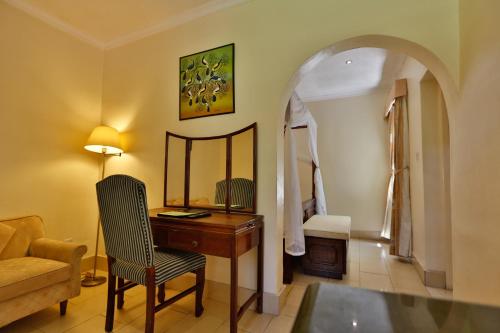 a room with a desk and a chair and a mirror at Muthu Lake Naivasha Country Club, Naivasha in Naivasha