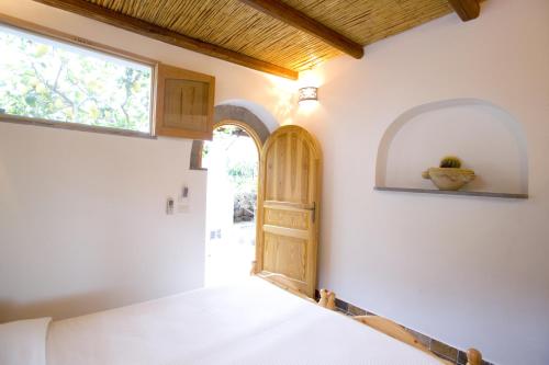 a bedroom with a door and a window at B&B da Luca in Panarea
