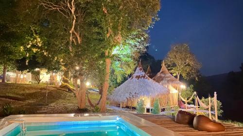 a resort with a swimming pool and a tent at Khanchong kawana in Phitsanulok