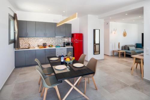 a kitchen and dining room with a table and chairs at Thiramor houses in Mesaria