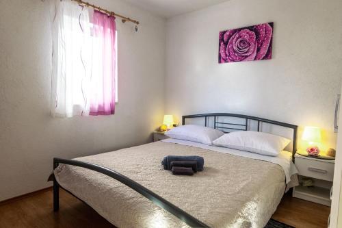 a bedroom with a bed with a bag on it at Holiday home Nancy with swimming pool in Vinišće