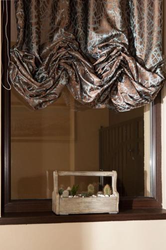 a mirror with a curtain and a fishtank in front of a window at Hotel Motto in Stara Zagora