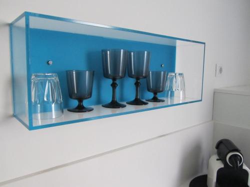 a glass shelf with three wine glasses on it at Los Balcones del Arte in Santander