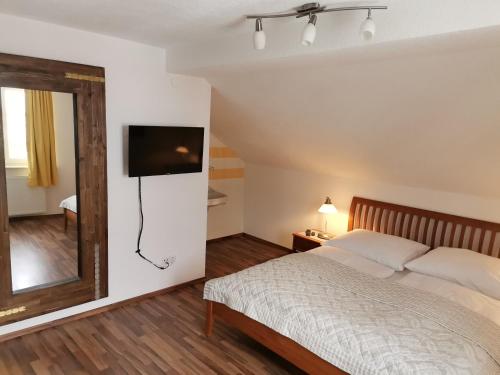 a bedroom with a bed and a mirror at Landhaus Kulm in Bad Mitterndorf