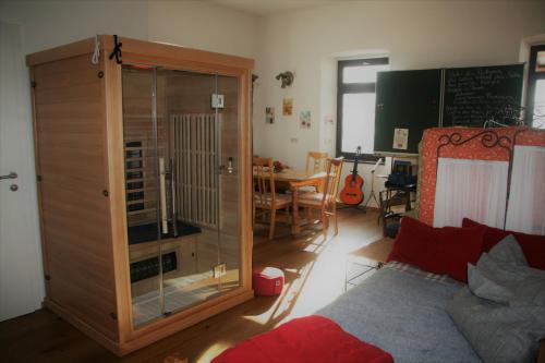 a living room with a large wooden cabinet and a table at Alte Volksschule - schual in gradne in Liebenfels