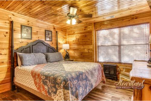 a bedroom with a bed and a ceiling fan at Southern State of Mind in Pigeon Forge