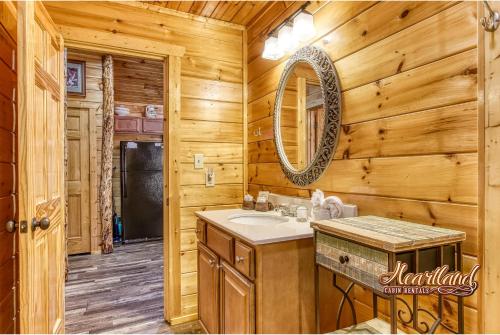 a bathroom with a sink and a mirror at Southern State of Mind in Pigeon Forge