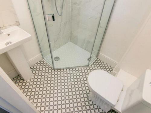 a bathroom with a shower and a toilet and a sink at Eastgate Hideaway - central, luxury apartment on Chester's historic rows in Chester