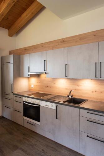 a kitchen with a sink and a stove top oven at Apartment Madlaina in Samnaun