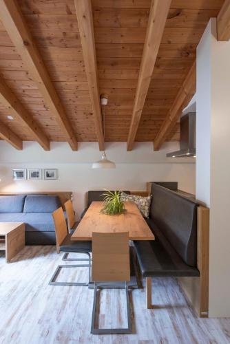 a dining room with a table and a couch at Apartment Madlaina in Samnaun