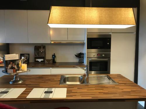 a kitchen with a sink and a counter top at Le petit béguinage in Tongeren