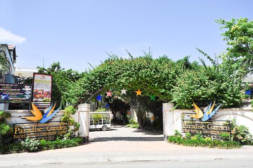 an entrance to a park with an arched gate at Paradise Garden Hotel and Convention Center Boracay Powered by ASTON in Boracay