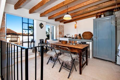 a kitchen with a wooden table and some chairs at Monte Sea View Residence in Rovinj