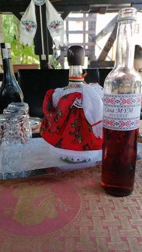 a bottle of sauce sitting on a table at Casa MYM in Moisei