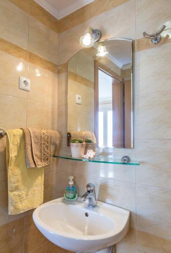 a bathroom with a sink and a mirror at Villa Rossa 2 in Tučepi