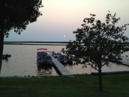 a boat is docked at a dock in the water at Lunge Haven Cottages & Boating Club in Lindsay