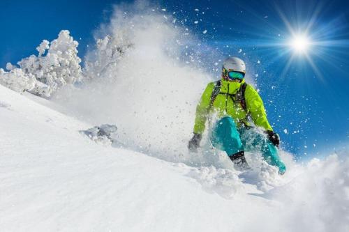 a person is skiing down a snow covered slope at Hotel Firenze in Fanano