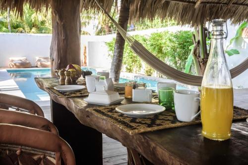 a table with food and a bottle of orange juice at Casa Blanca in Holbox Island