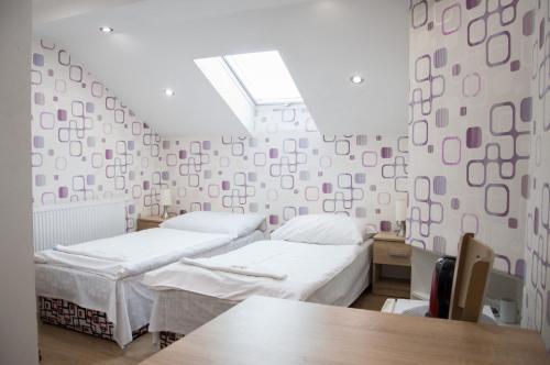 a hospital room with two beds and a table at Penzion Adriana in Jiříkov