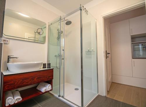 a bathroom with a sink and a shower at B&B Rooms Old Town Rab in Rab