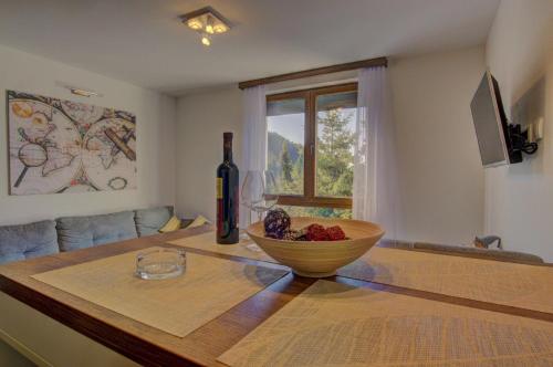 a kitchen with a table with a bowl of fruit on it at Gorštak-Šeha in Jahorina